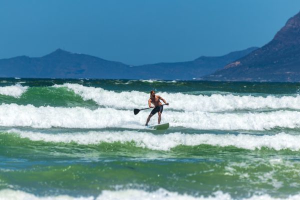 A paddleboarder is facing Second Degree Assault charges for hitting a surfer with his paddle while arguing about a wave.